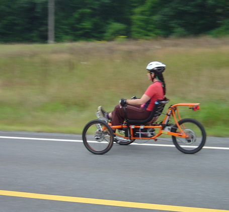 E rides Orange trike