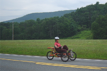 E rides Orange trike